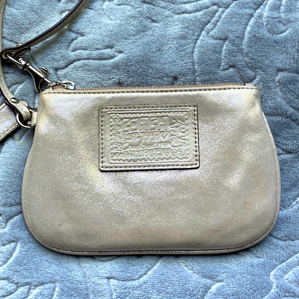 Coach Wristlet in Shiny light Gold with Lilac Silky Interior.